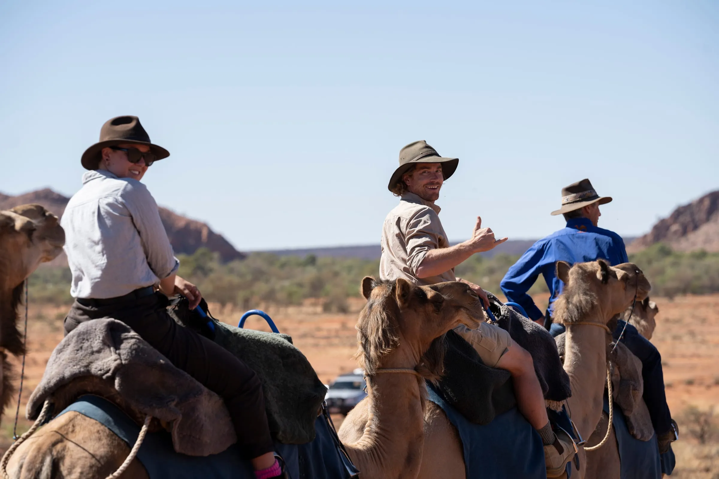 Hayden Quinn riding a camel in the Red Centre