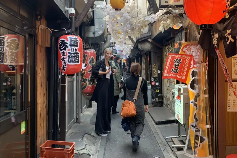 Narrow alley of small bars hung with red paper lanterns